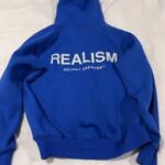 Community Over Commodity The Realism Hoodie
